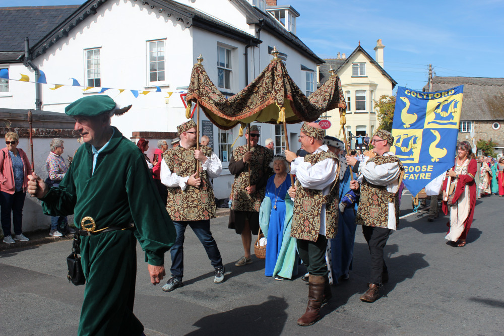 The fayre gets underway with the procession of villagers in costume