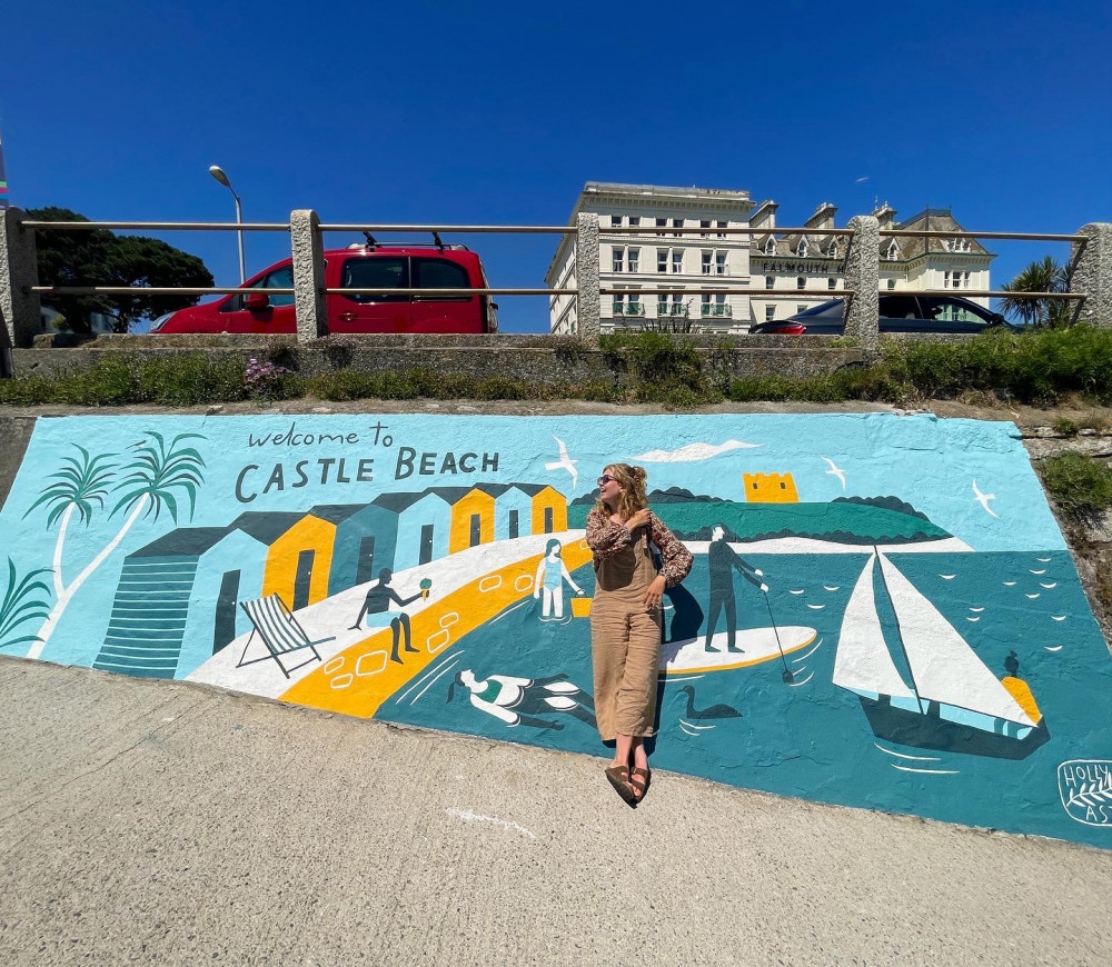 Holly Astle stood in front of her mural at Castle Beach.