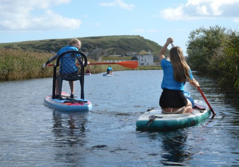 Paddle boarders make a start on the clean-up operation. Shared by Mayor Ian Bark.