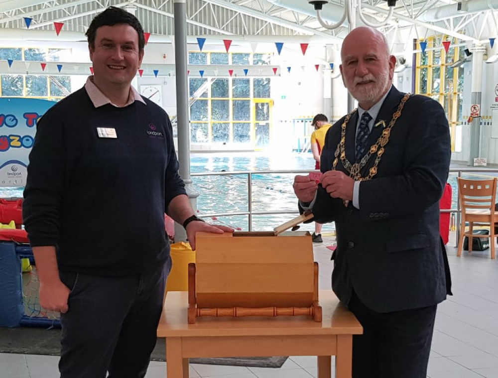 Centre Manager Will Thrower draws the raffle with Mayor Ian Bark.