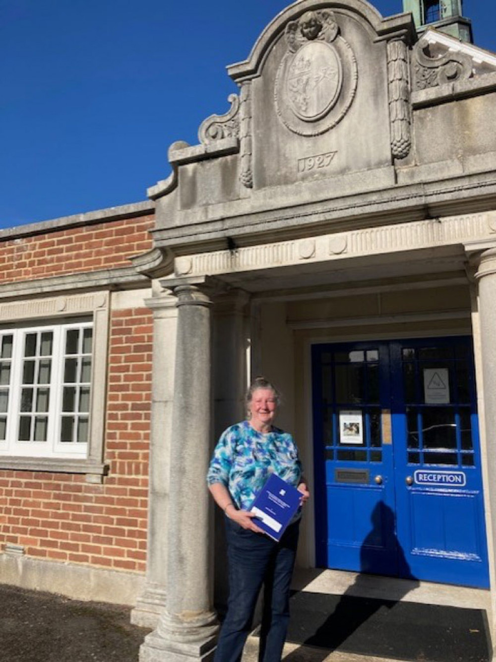 Author Sarah Charman with her book, pictured outside Colyton Grammar School