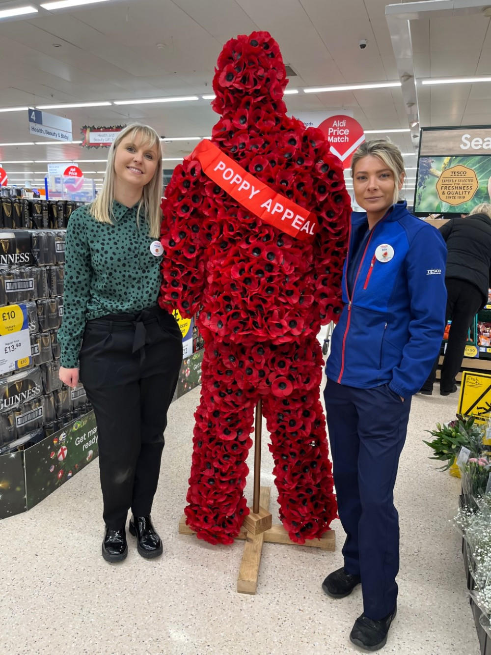 The 'Poppy Man' pictured with Tesco manager Helen Collins and and shift leader Amanda Fletcher.