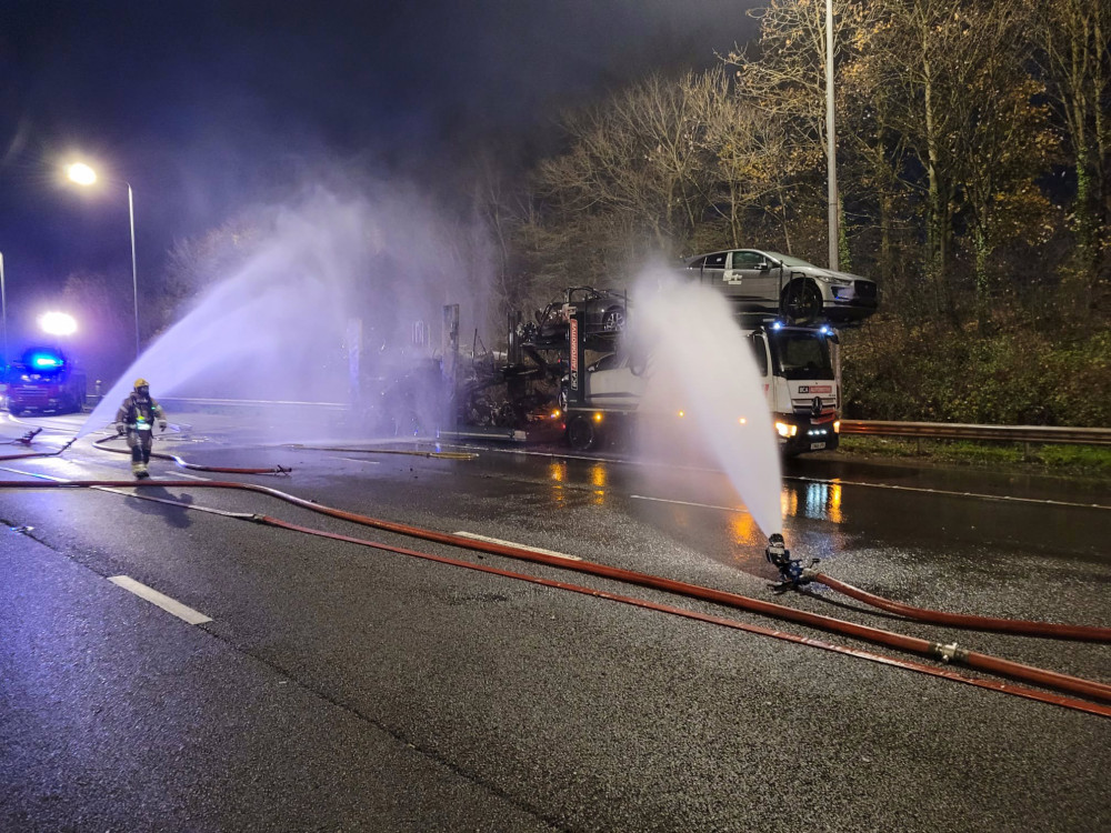 Hucknall firefighters are dealing with a fire involving a car transporter on the M1 South between Junction 26 and 27 which initially closed both carriageways. Photo courtesy of NFRS.