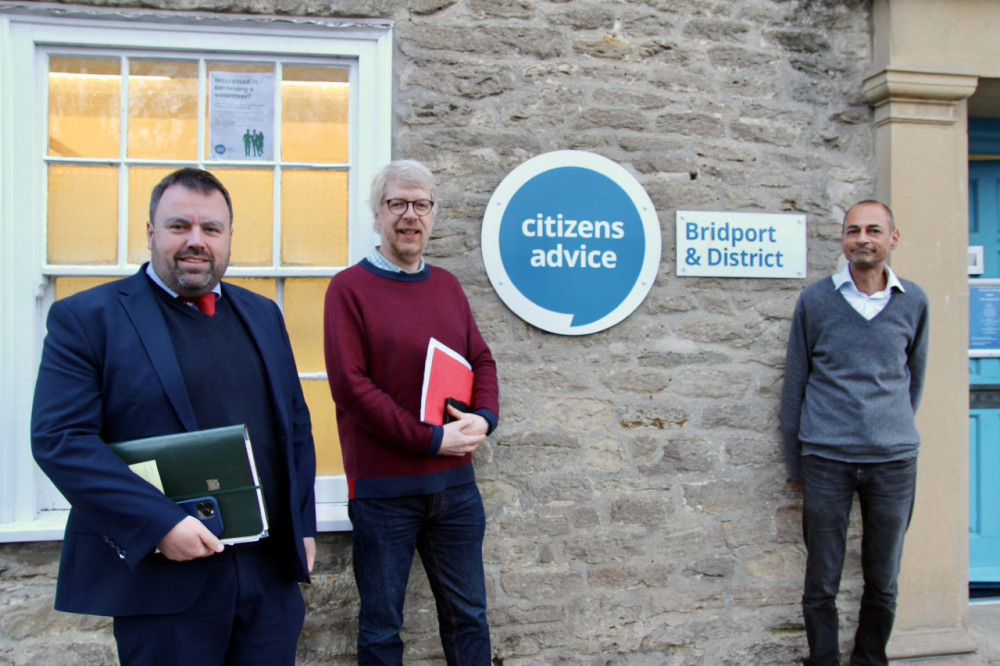 Chris Loder MP (far left) with Daniel Cadisch (centre) and Rovarn Wickremasinghe of Bridport & District Citizens Advice