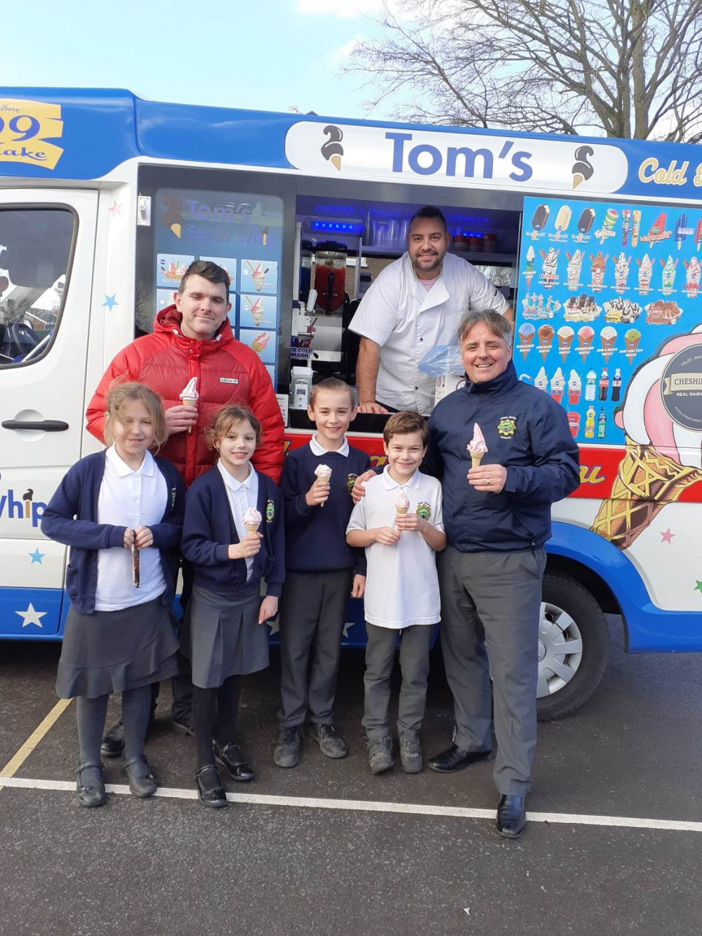 Carl Leech (far right) with deputy head John Frankland and some Year 4 pupils enjoying their treat. 