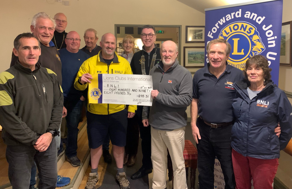 Exmouth RNLI volunteers receive the cheque from Budleigh Lions Club members (RNLI)