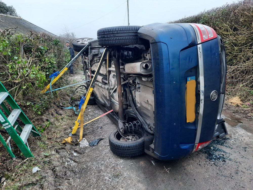 A car ended up on its side with one person trapped inside after hitting ice (photo credit: Charmouth Fire Station)