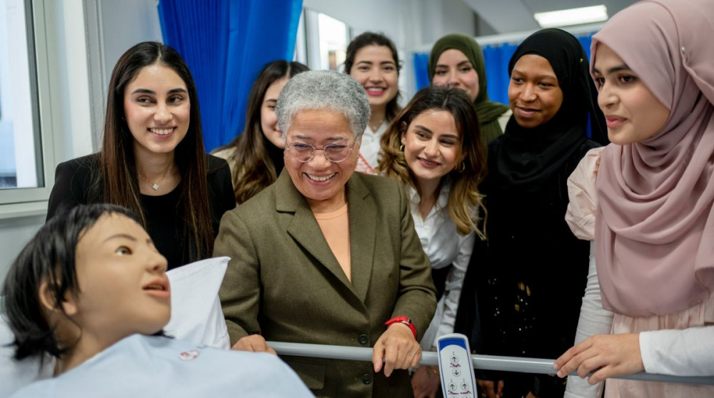 Dame Elizabeth Anionwu (centre) with Kingston students as she opened the University's brand-new pharmacy skills simulation suites (Credit: Kingston University).