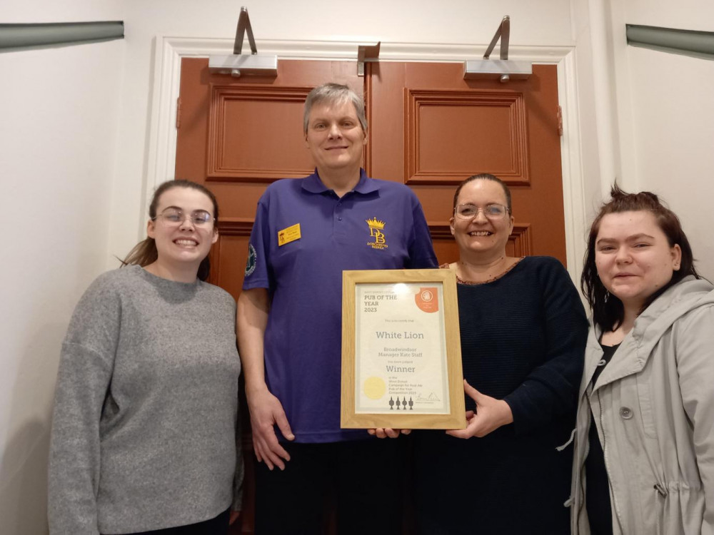 West Dorset CAMRA chairman Bruce Mead presents the 2023 West Dorset CAMRA Pub of the Year award to Kate Staff (centre) and daughters Chloe (left) and Louise from The White Lion, Broadwindsor