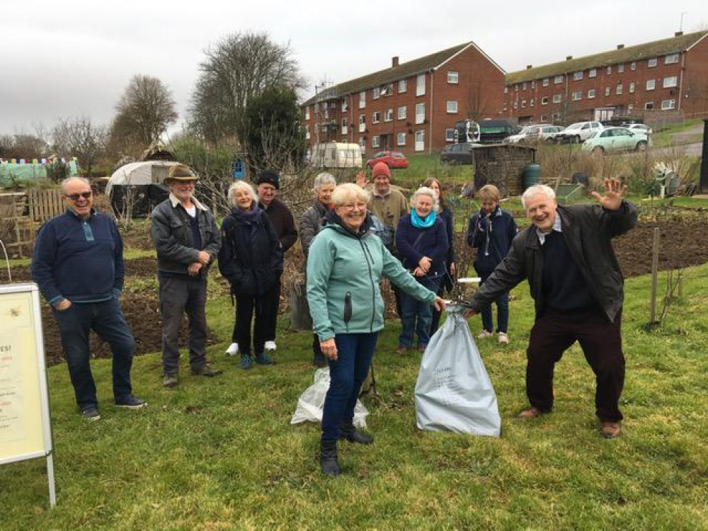 Joe Hackett, co-ordinator of Bridport Tree Planting, hands over the trees to the chair of the allotments association, Fiona Dare