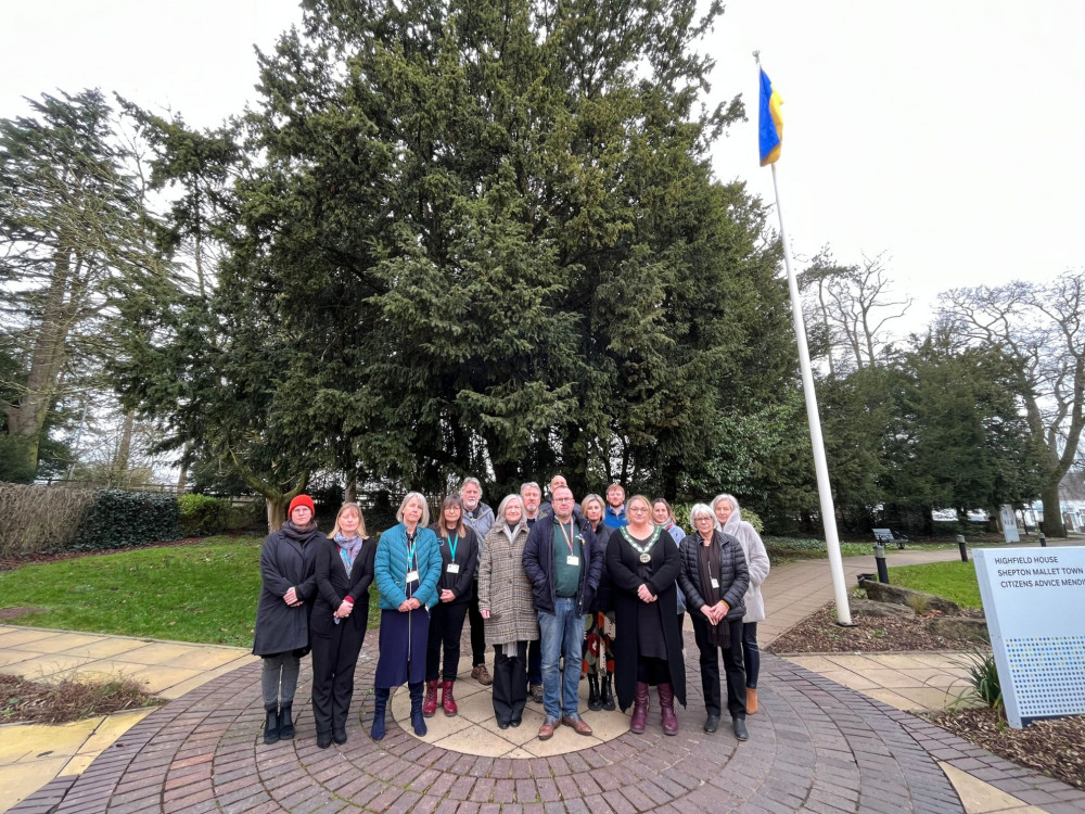 Mendip District Council members and staff gather under the Ukrainian flag at the council offices, for the national one-minute silence on the anniversary of Russia's invasion.