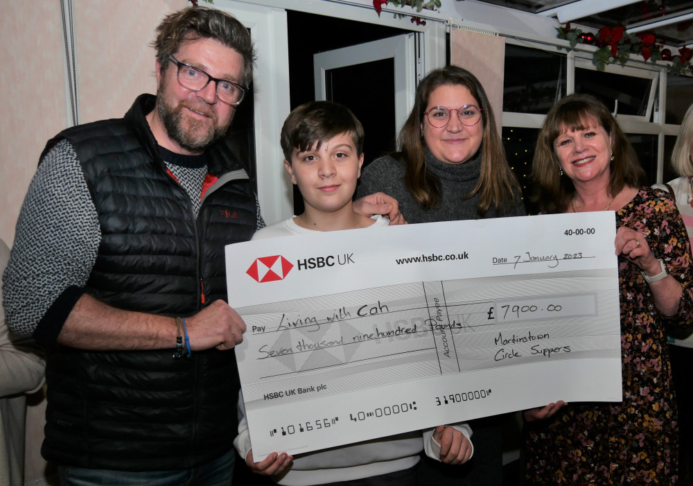 Owners of the Brewers Arms in Martinstown, Leanne and Ben Carter, with one of their sons and Roelie Newman of Martinstown Circle Suppers, holding the cheque for £7,900 raised for the charity Living with CAH