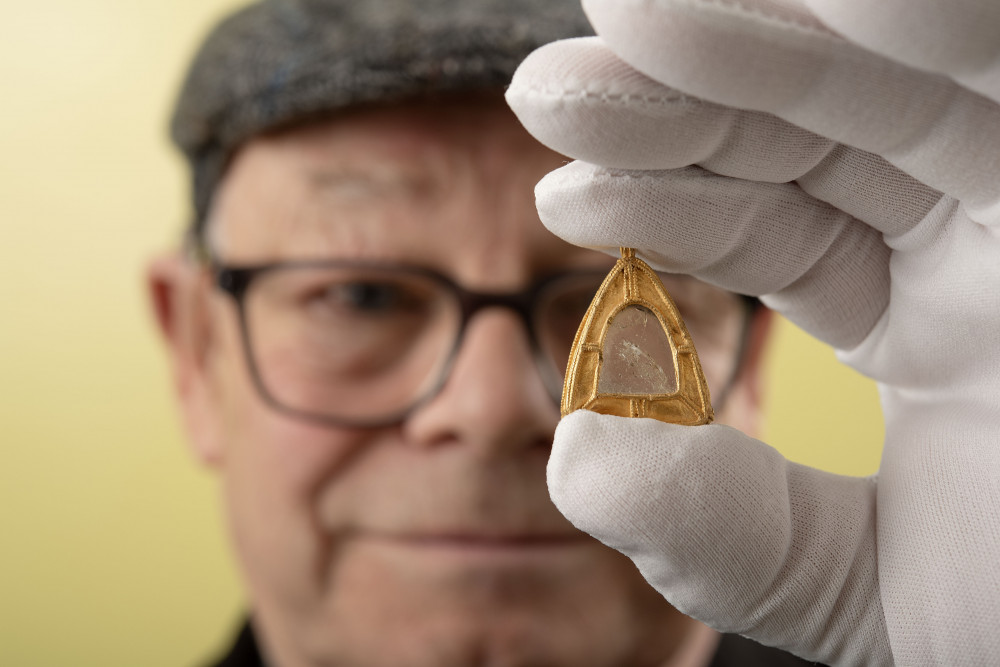 Metal detectorist Charles Bullock, 68, with the rare gold and rock crystal pendant (photo credit: BNPS)