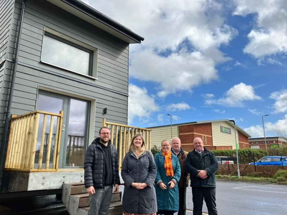 Cllr Dan Ledger, Jo Garfoot, Cllr Eleanor Rylance, Cllr Paul Arnott and Paul Lees stood by the modular house in Honiton