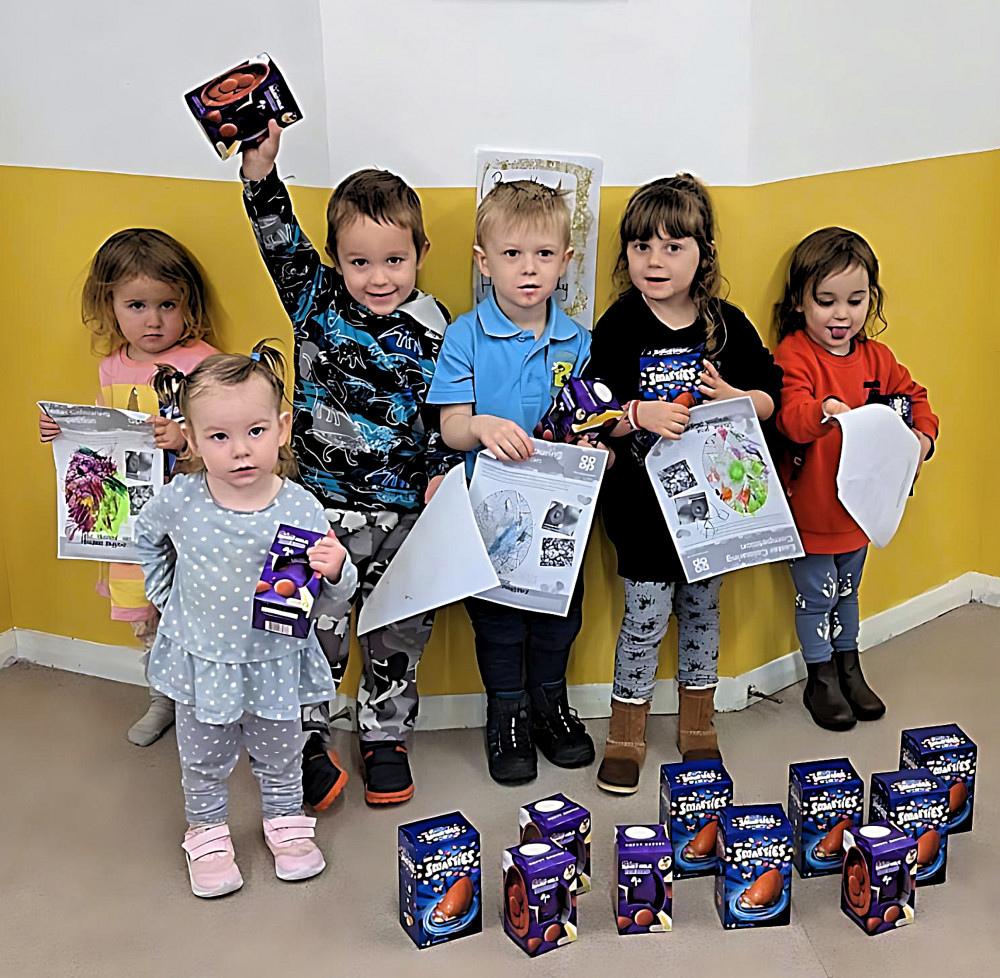 The children at Honeybees Playground with their competition entries and prizes