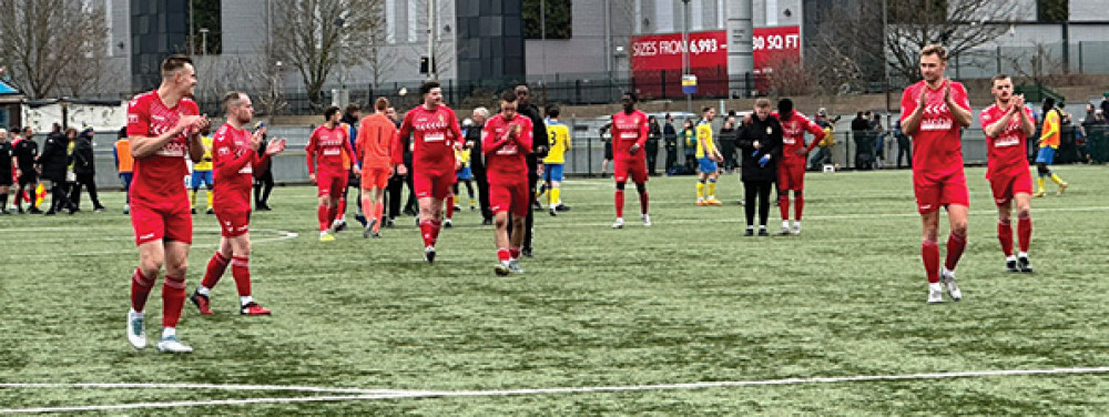 Aveley fans salute their supporterss at the end of Saturday's match