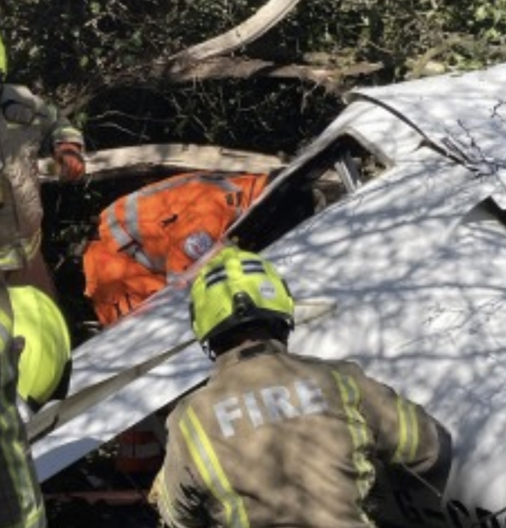 Firefighters extricate the two people from the wreckage