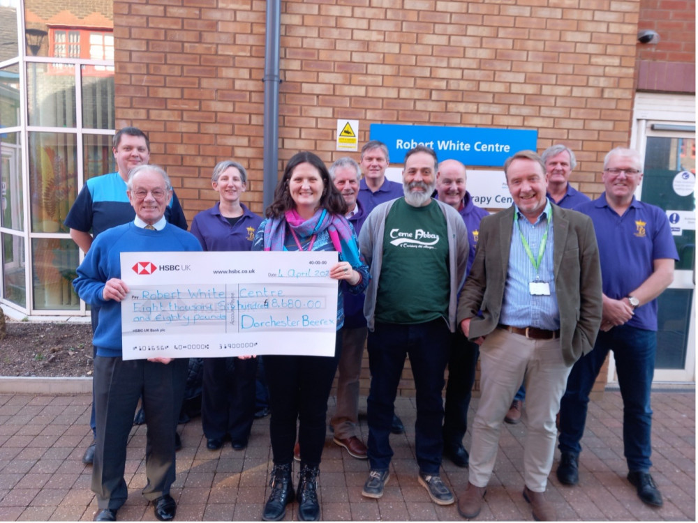 Chris Davies of Dorchester Casterbridge Rotary Club and West Dorset CAMRA Beerex Committee members present a cheque to Victoria Hunt of the Robert White Centre, with Cerne Abbas Brewery director Vic Irvine and Dorset County Hospital head of charity Simon Pearson (photo credit: Rich Gabe)