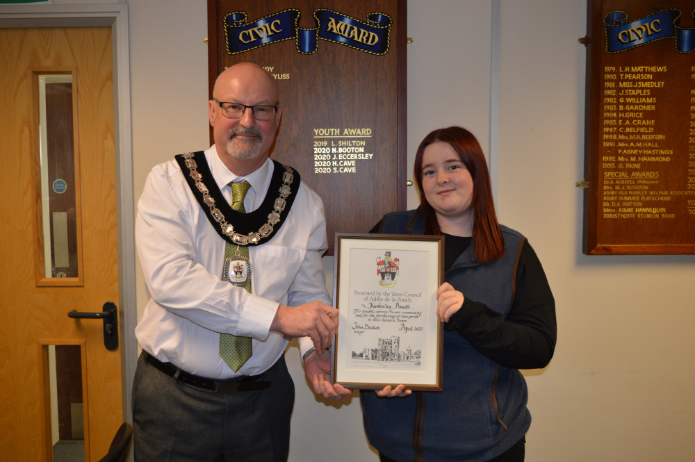 Kimberley Aucott receives her award from the Mayor of Ashby, Cllr John Deakin. Photos: Ashby Town Council