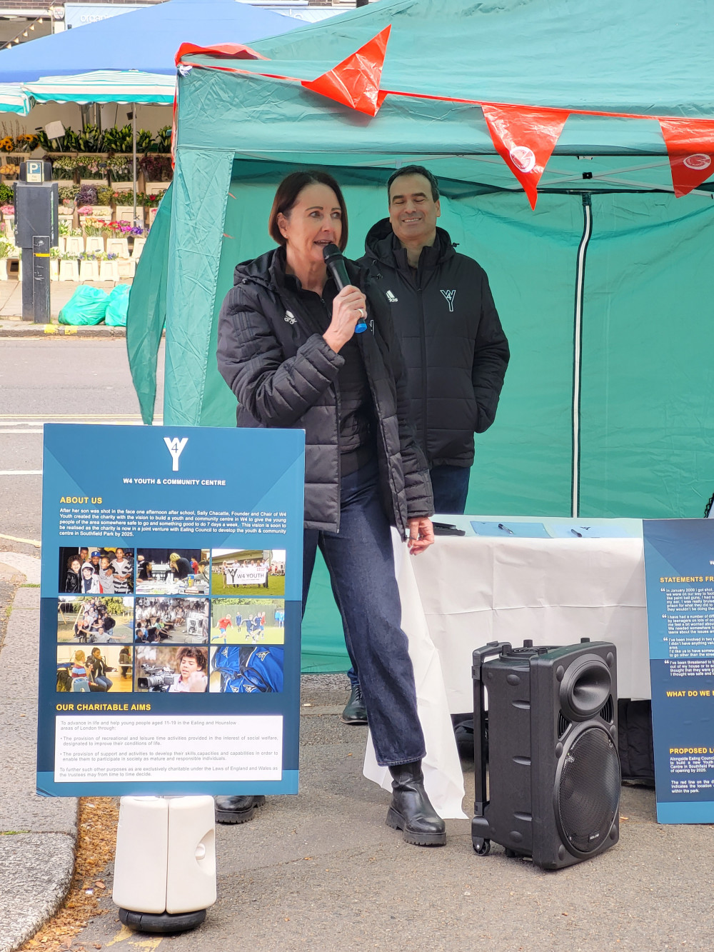 W4 Founder Sally Chacatté introducing the dancers with Trustee Marcel Chacatté at the stall