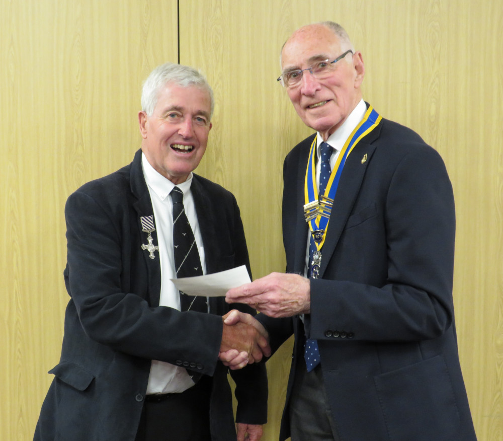 Warwick Rotary Club president Keith Talbot (right) with Alistair Price wearing his father’s medals (Image supplied)