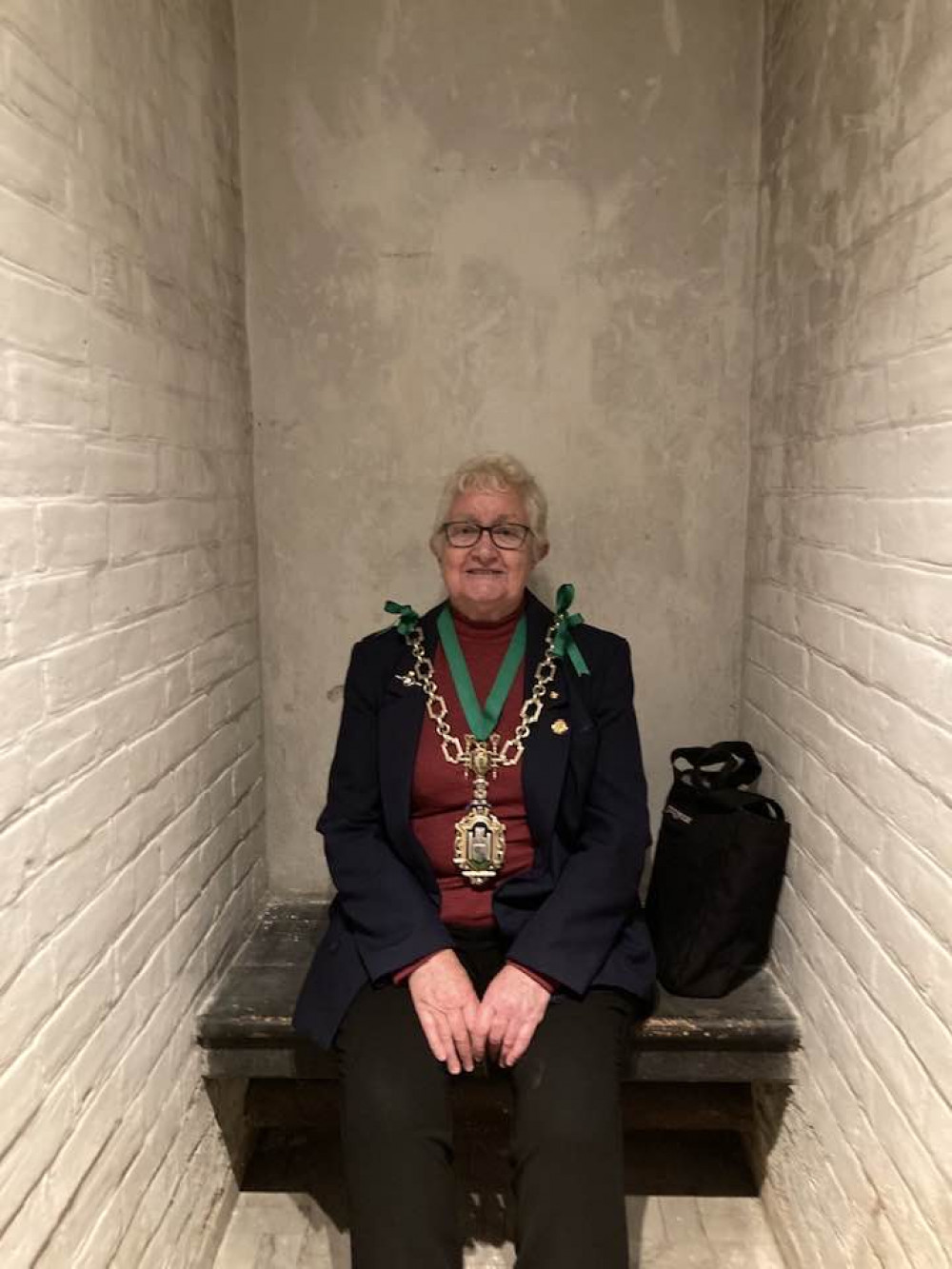 Cllr Janet Hewitt tries out one of the cells at Shire Hall Museum (photo credit: Discover Dorchester/Dorchester Town Council)