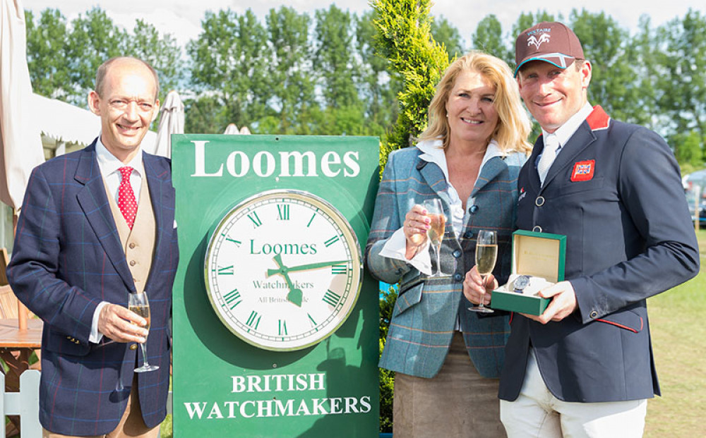 Robert and Robina Loomes-Hill present a hand made watch to Oliver Townend. Image credit: Loomes of Stamford.