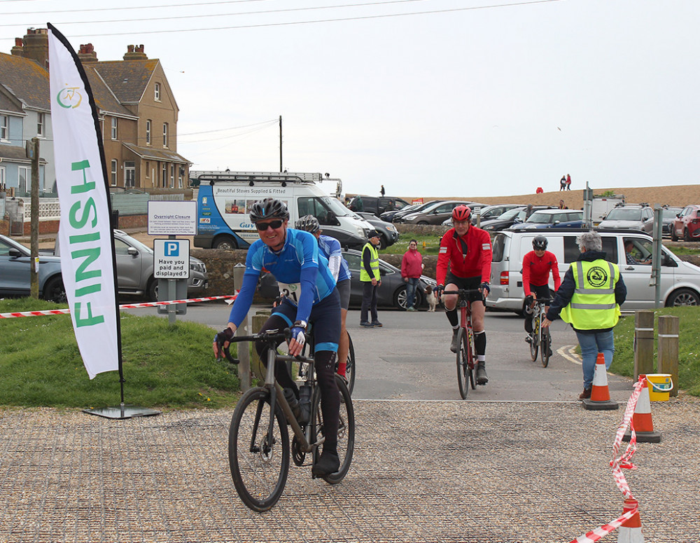 Cyclists arrive at the finish line in West Bay