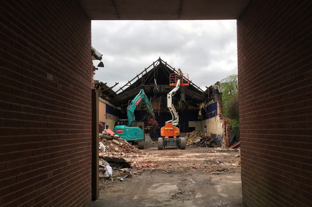 Viewed through the archway – demolition underway