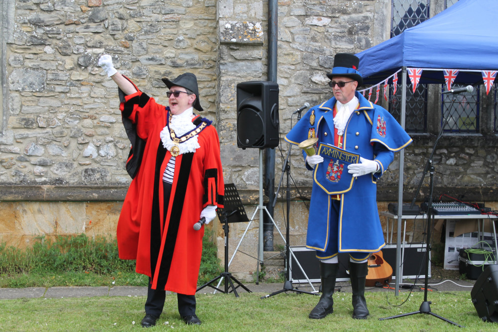 The Mayor of Axminster, Cllr Jill Farrow, and town crier Nick Goodwin in his new uniform, lead the celebrations on the Minster Green (photo credit: Philip Evans)