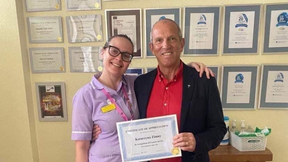 Managing Director Keith Mills giving staff member Katie Zimny certificate of appreciation (Doveleigh Care)