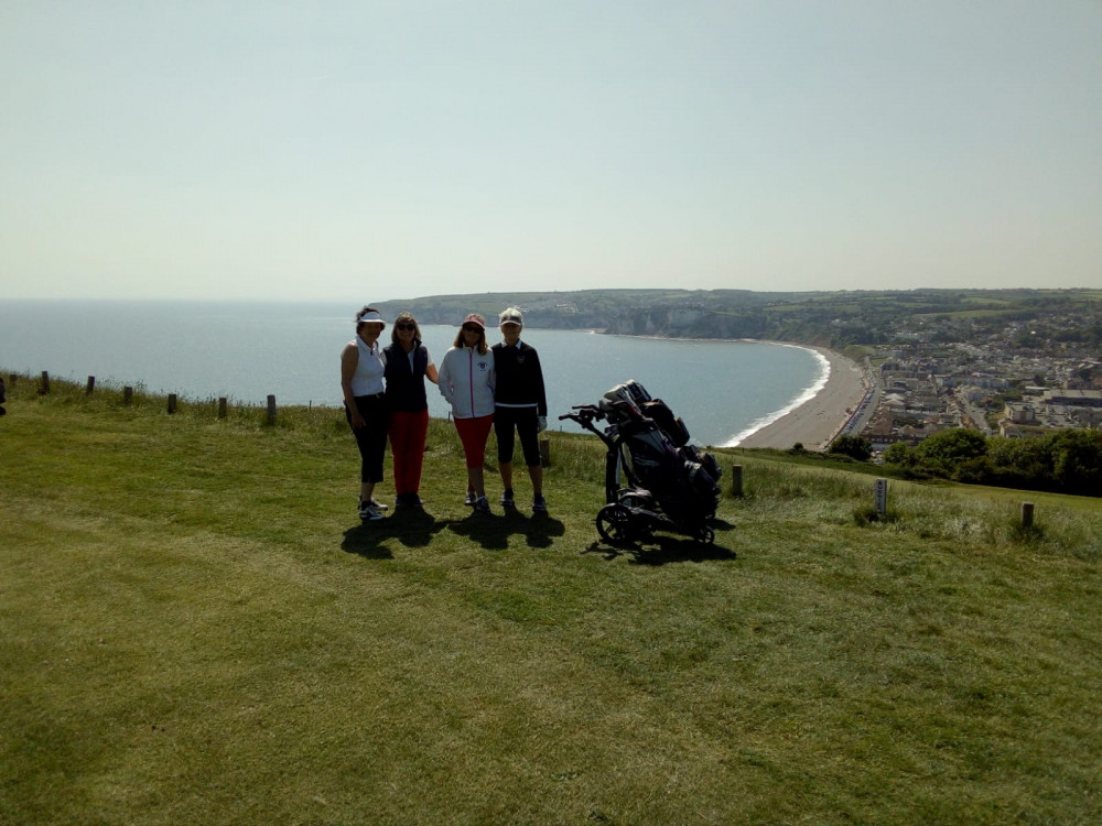 Captain Stella Thompson (first left) and Pauline Willis (last right)with their Bridport opponents all deciding what club to take on the infamous 16th hole at Axe Cliff Golf Club