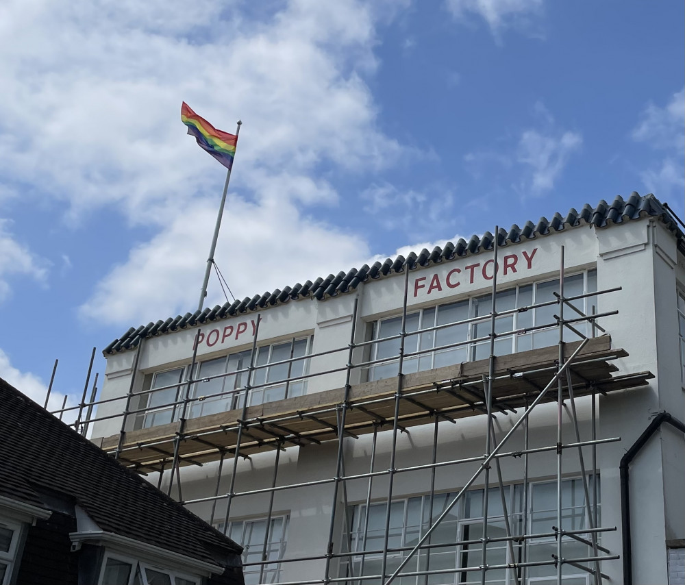 The rainbow Pride flag flying on the roof of The Poppy Factory