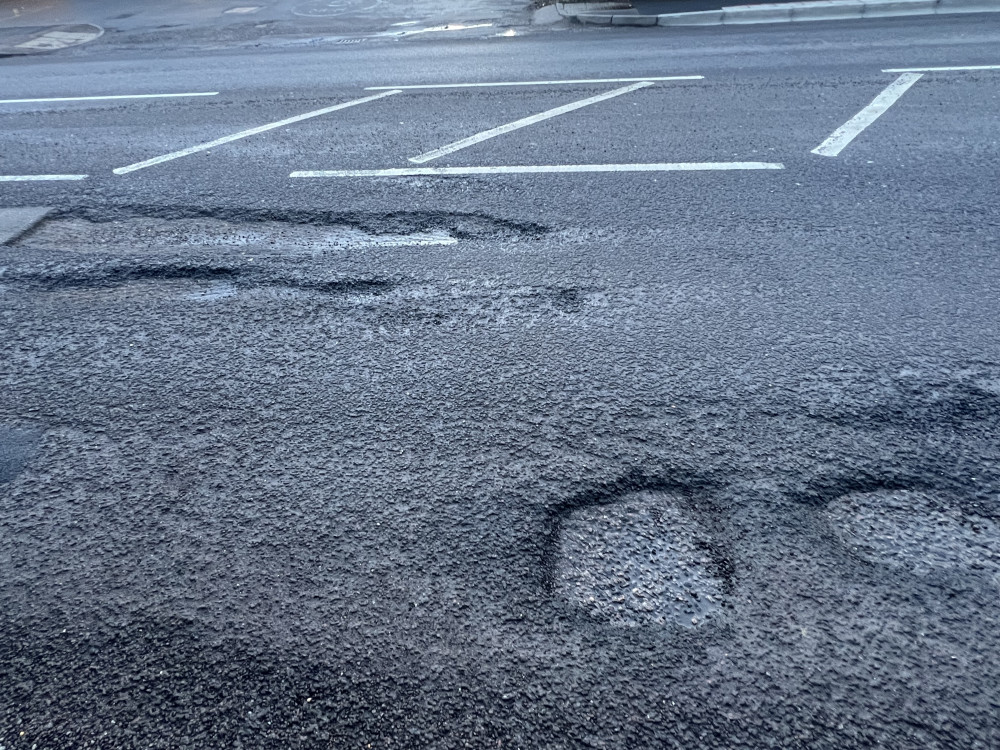 Three Worst Pothole Plagued Roads In Hitchin: Tell us your worst potholes in our town. PICTURE: Pothole craters outside Kwik Fit on Bedford Road. CREDIT: Nub News