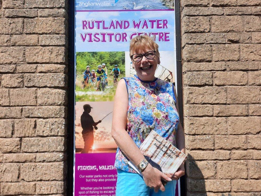 Tracey with a copy of Oncar's Adventure at Rutland Water. Image credit: Nub News. 