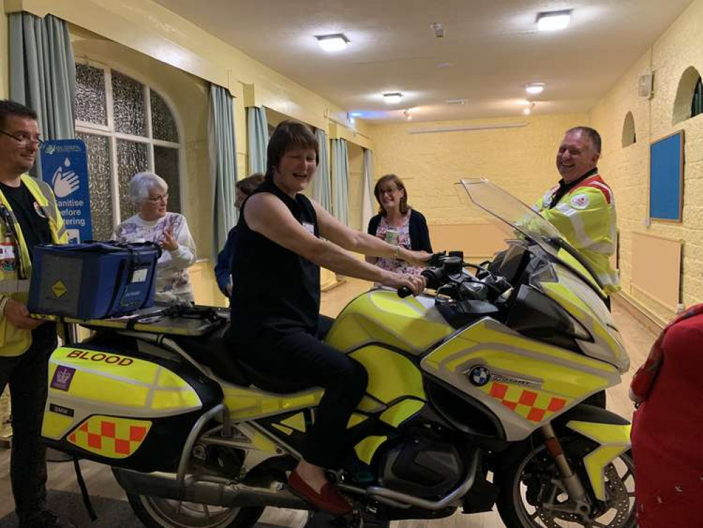 Bont Faen WI President ,Sue Bradshaw tries out the Blood Bike.