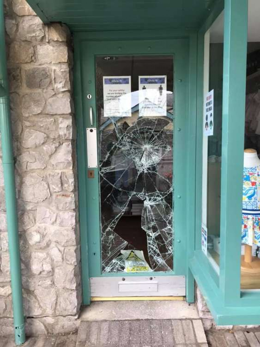 The shattered glass door at Little Sweethearts Childrenswear (Image by Sian Coleman)