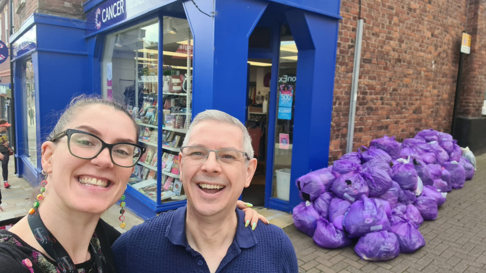 Laura and Simon outside Congleton's Cancer Research UK Store with half of the group's donations.