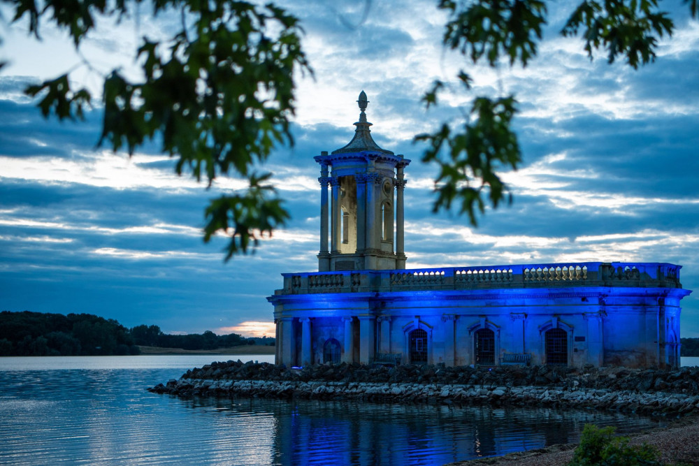 Normanton Church was be lit up blue last night to mark the 75th anniversary of the NHS. Image credit: Alan Walters.