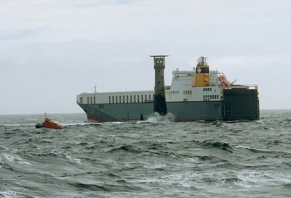 The dramatic moment the cargo ship came close to hitting Wolf Rock lighthouse. (Image: SWNS) 