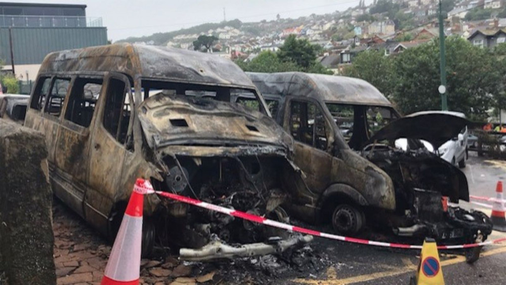 Burnt-out minibuses in Barton Hill car park, Dawlish (DCT)