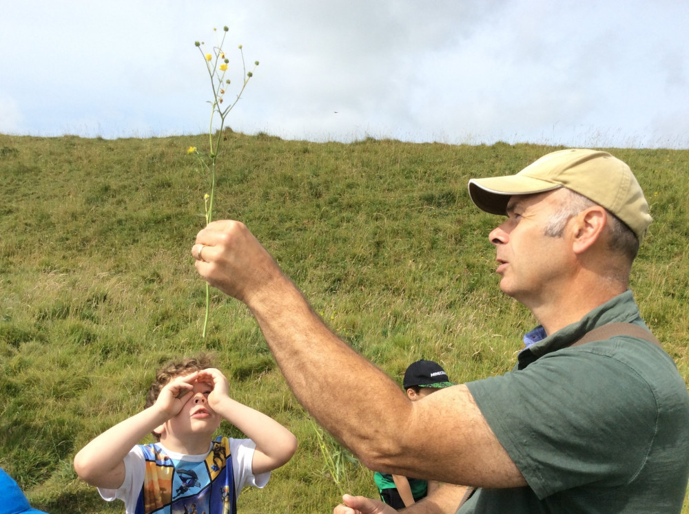 Poundbury Nature Project creator Miles King, from the charity People Need Nature, talks to thew children about wildflowers