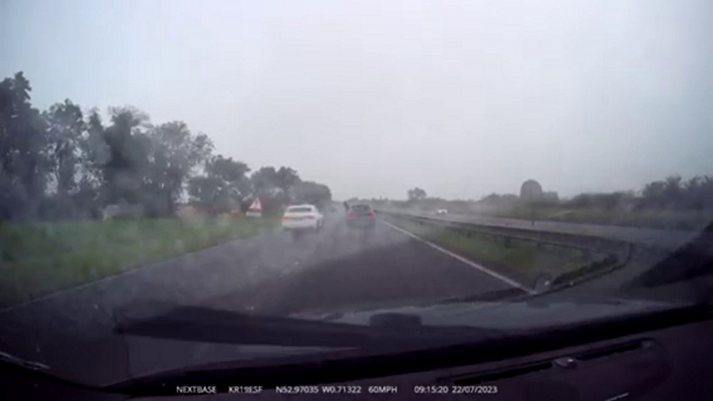 Dashcam footage caught a passenger hanging out of a BMW on the A1. Image credit: SWLN. 