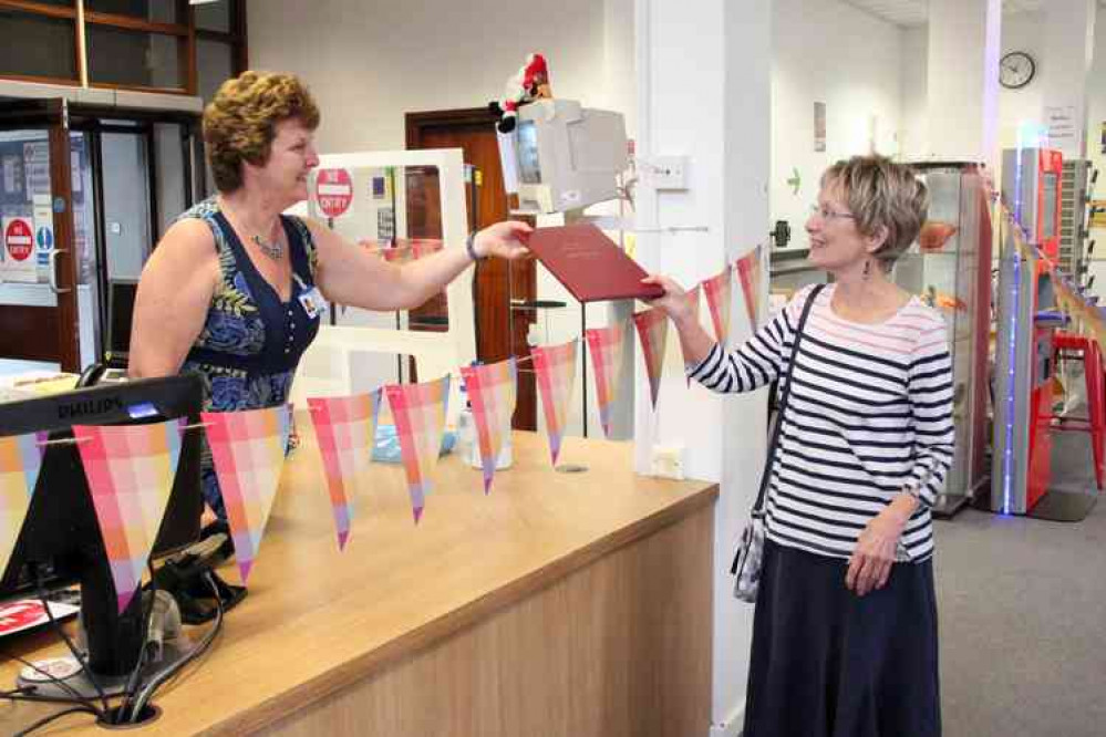 Maggie donating a copy of her book to Strode College Learning Zone