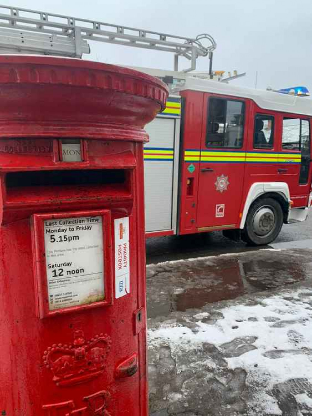 A Cheddar fire crew at the postbox that was set alight (Photo: Cheddar Fire Station)