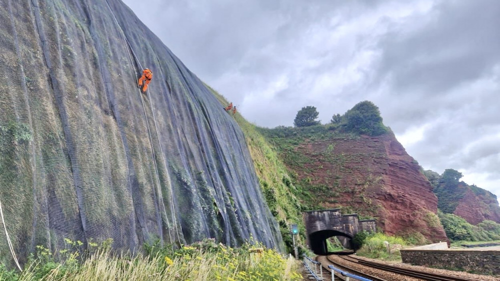 Installing temporary grey matting (Network Rail)