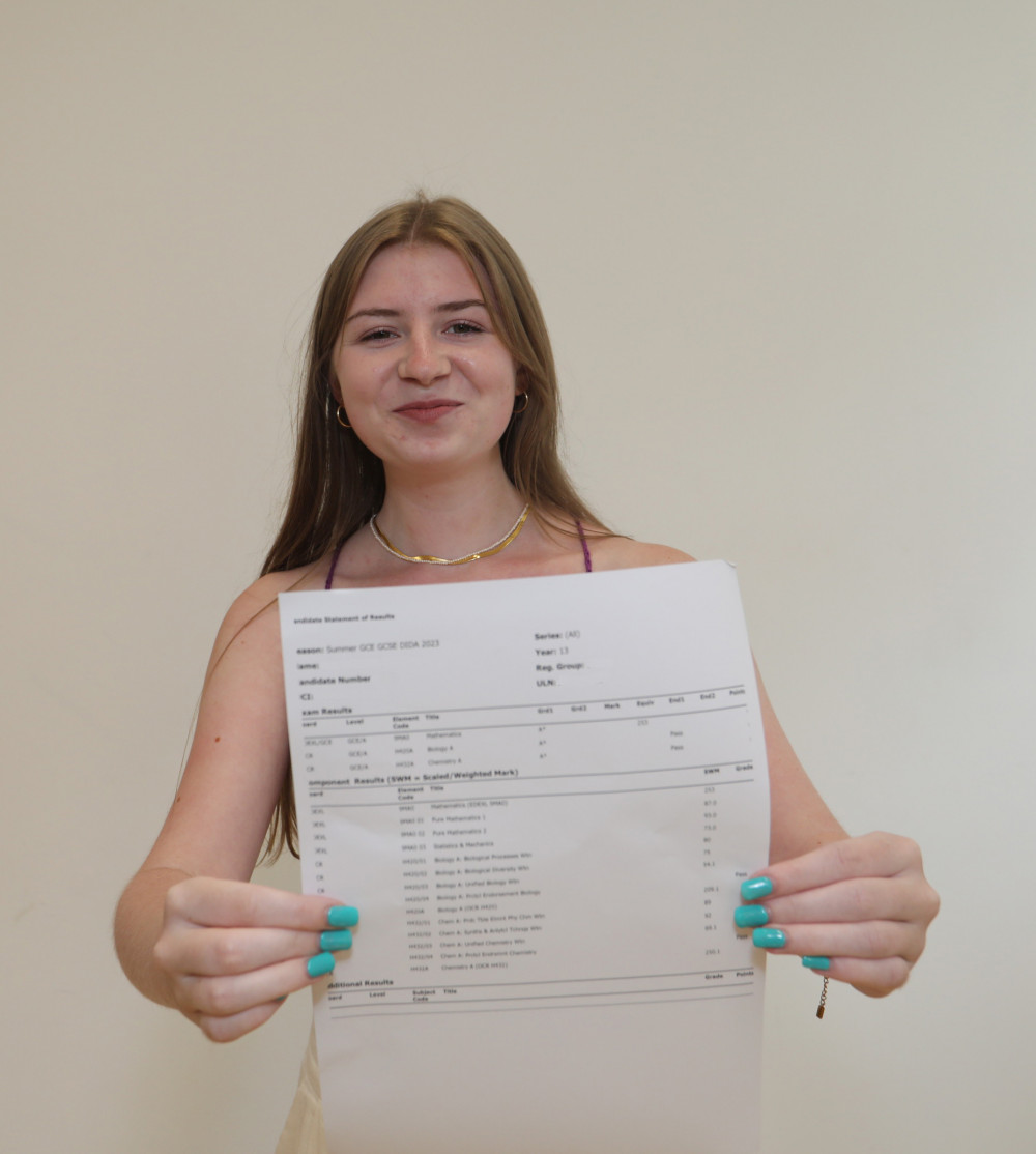 Corinne showing her A*A*A* results. (Photo: Hollyfields School)