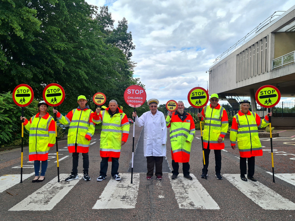 Serving members of the school crossing patrol team, including Sandie Flamson (Centre) celebrating 50 years and dressed in the original crossing patrol outfit. Photos: Leicestershire County Council