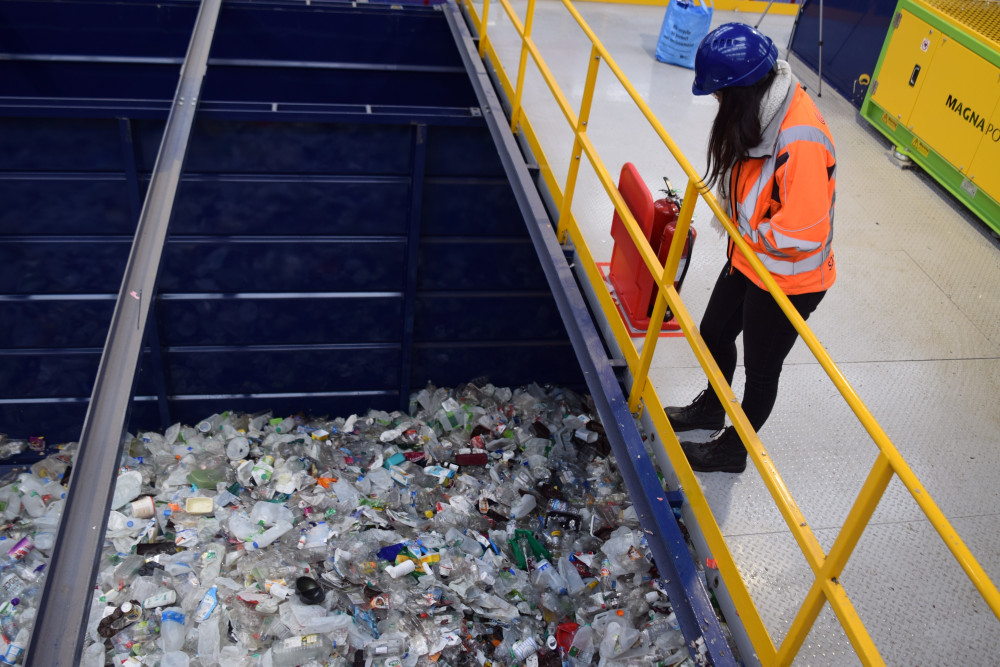  A member of staff from Suez looks at the plastic that has been collected for recycling.