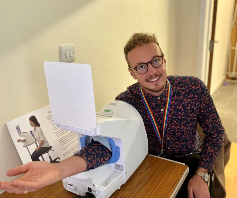 Cllr Adam Dance having his blood pressure checked